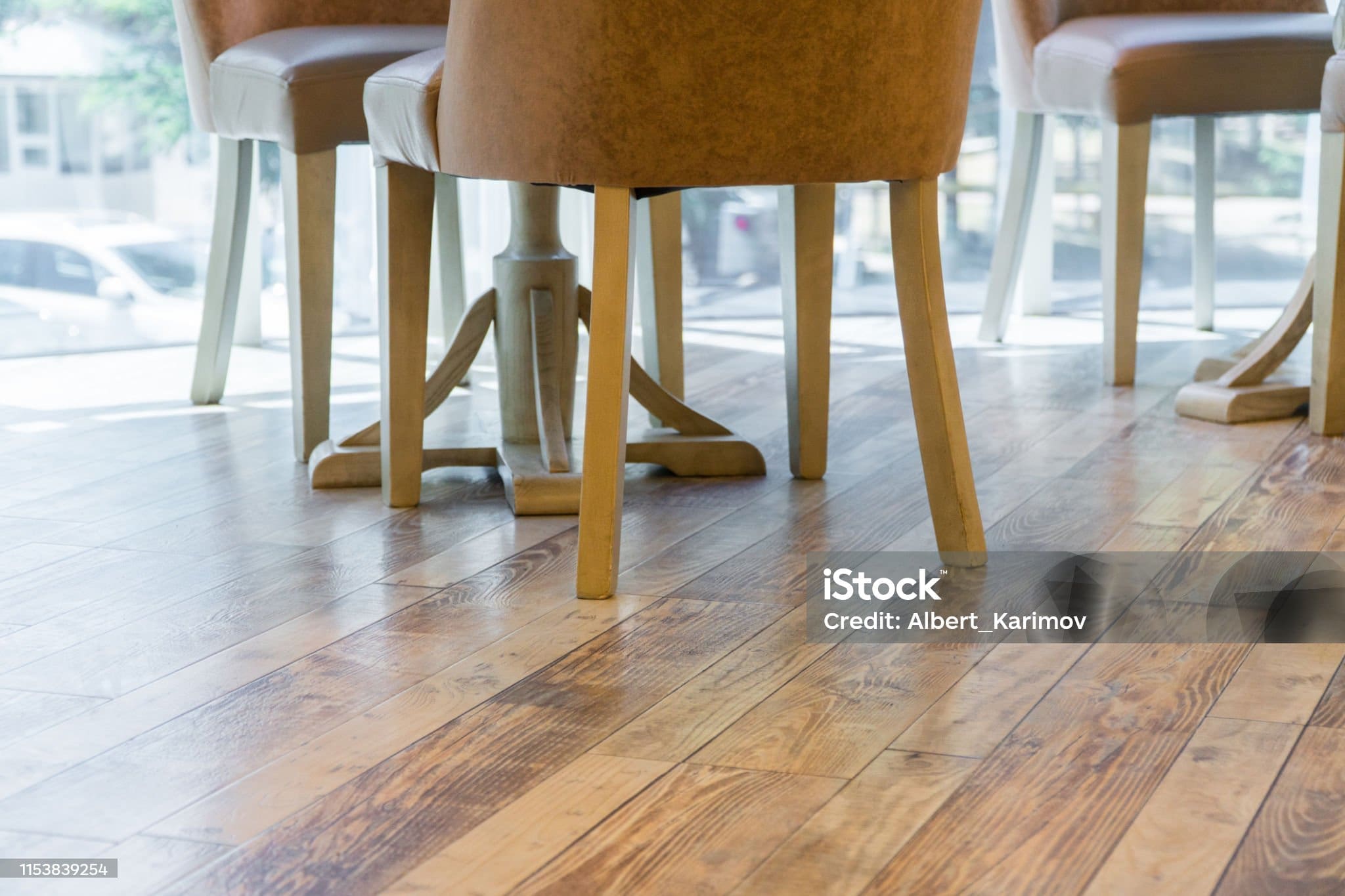 legs of chairs on the wooden floor of the restaurant, close-up