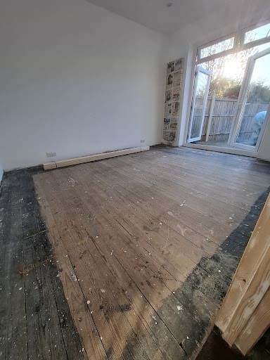 Unsanded floor in Essex after carpet has been pulled up.  It is damaged faded and scratched
